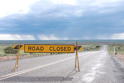 Road closed sign along countryside landscape