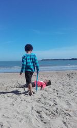 Boys playing on shore at beach