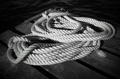 Close-up of rope tied on wood