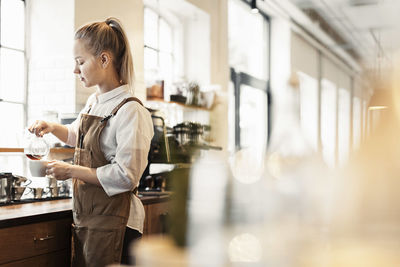 Barista preparing coffee at cafe counter