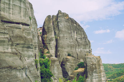 Low angle view of rock formations against sky