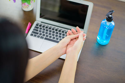 High angle view of person using laptop on table