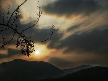 Scenic view of silhouette mountains against sky at sunset