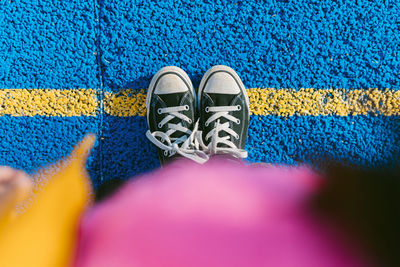 Girl standing on marking at blue sports court