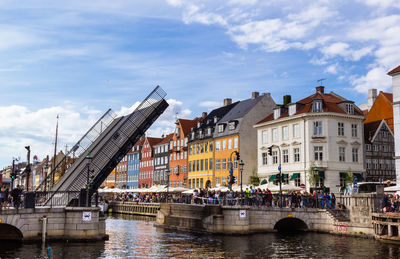 People waiting for going up drawbridge at nyhavn waterfront