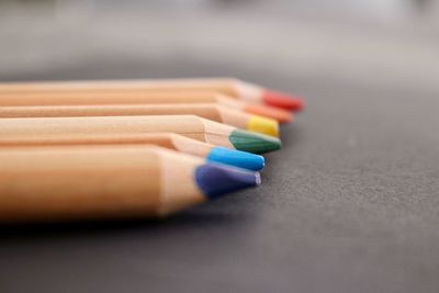 Surface level of wooden colored pencils on blackboard