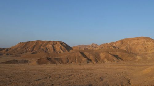 Scenic view of arid desert at sunrise 