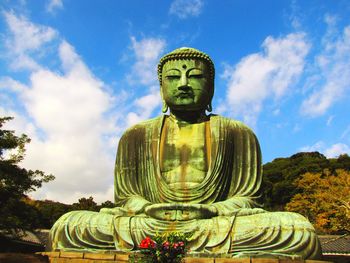 Low angle view of statue against sky
