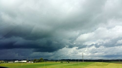 Scenic view of landscape against cloudy sky