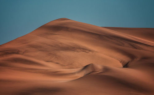 Scenic view of desert against clear sky