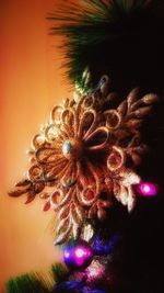 Close-up of illuminated christmas tree against sky