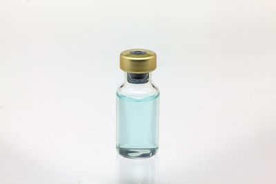 Close-up of glass bottle against white background