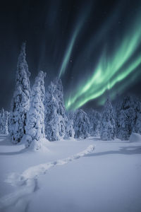 Scenic view of snow covered mountain against sky at night