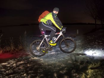 Man riding bicycle at night