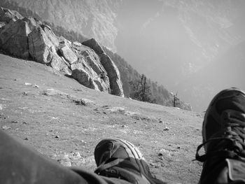 Low section of woman standing on landscape