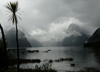 Scenic view of mountains against cloudy sky