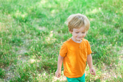 Happy boy standing in grass