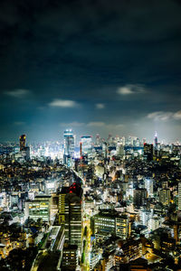 High angle view of illuminated cityscape against sky at night