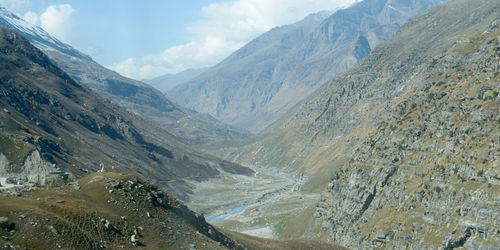 Scenic view of valley and mountains against sky