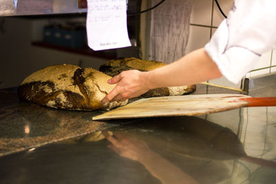 Cropped hand of man preparing food