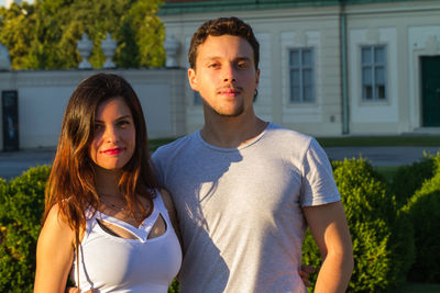 Portrait of young couple standing outdoors