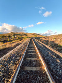 Surface level of railroad tracks against sky