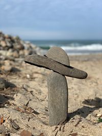 Close-up of stones on beach against sky