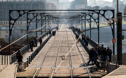 High angle view of people on railway bridge in city