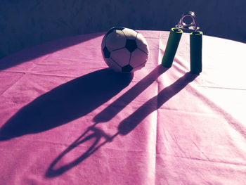 Toy soccer ball with exercise equipment on table