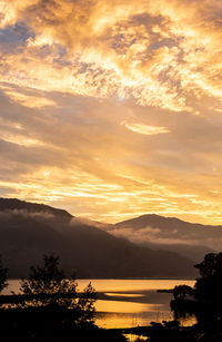 Scenic view of lake against romantic sky at sunset