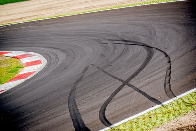 High angle view of tire tracks on road