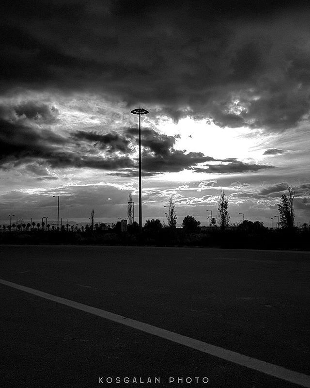 sky, cloud - sky, road, transportation, cloudy, street light, silhouette, cloud, the way forward, electricity pylon, street, overcast, road marking, weather, dusk, empty, outdoors, car, nature, tranquility
