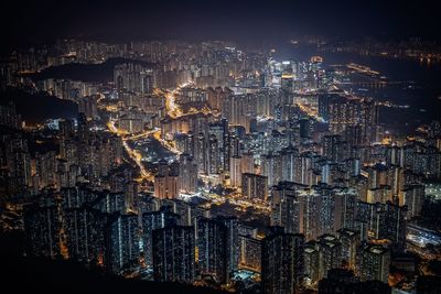 Illuminated cityscape against sky at night