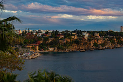 View of townscape by sea against sky