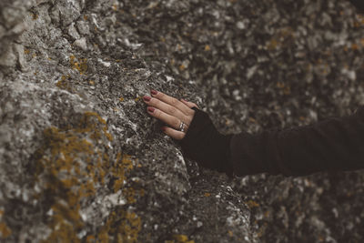 Female hand touching rocks