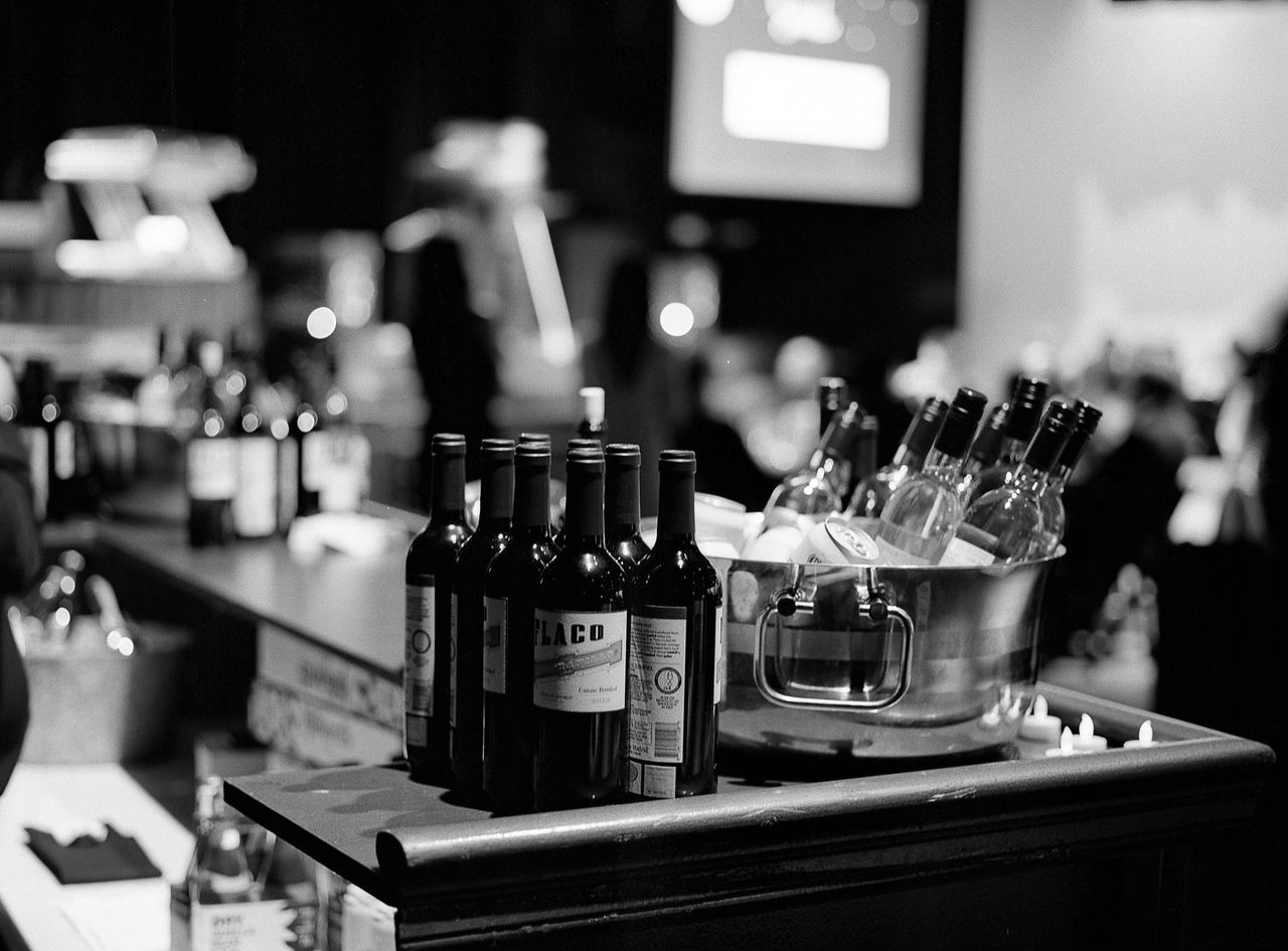 indoors, table, focus on foreground, still life, close-up, selective focus, food and drink, technology, candle, home interior, no people, large group of objects, shelf, variation, bottle, illuminated, restaurant, arrangement, domestic kitchen, music