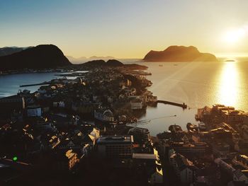 High angle view of town by sea against sky