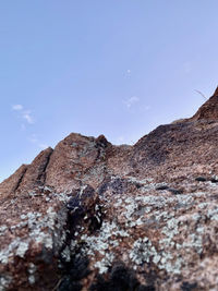 Low angle view of rock formation against sky