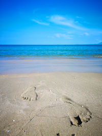 Scenic view of beach against blue sky