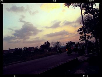 Road against cloudy sky at sunset