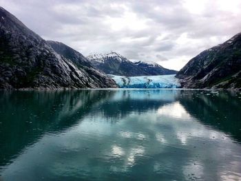 Scenic view of lake against cloudy sky