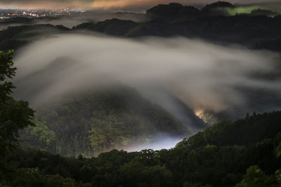 View of mountains during foggy weather at night