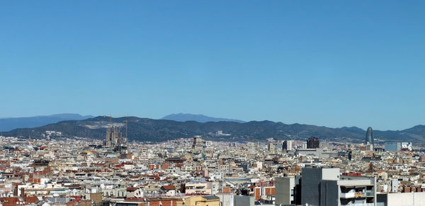 High angle view of townscape against clear blue sky