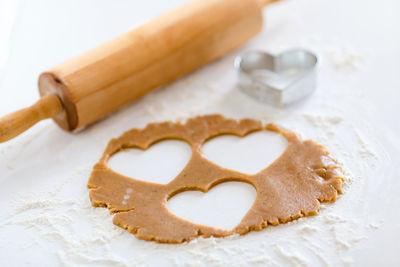 Close-up of heart shape biscuit dough on table