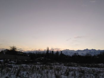 Scenic view of field against sky during winter