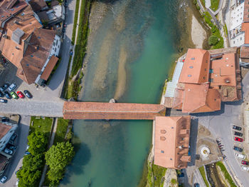 High angle view of covered bridge over river in city