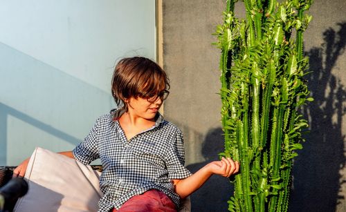 Rear view of boy against plants