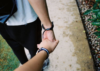 Low section of man standing on hand