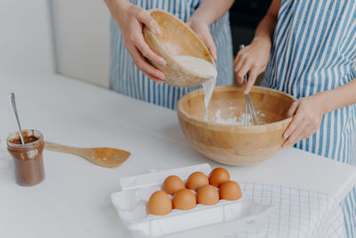 Midsection of man preparing food on table