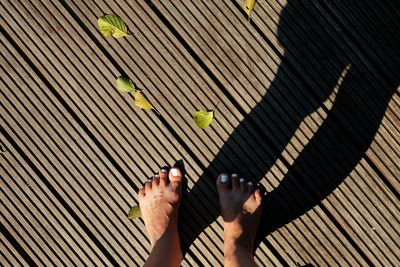 Low section of woman walking on tiled floor